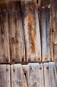 Old wooden door a with rusty lock