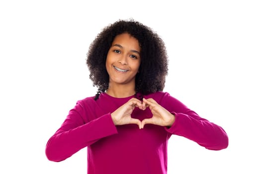 Teenager girl with afro hair wearing pink sweater isolated on a white background