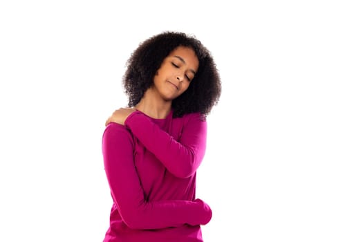 Teenager girl with afro hair wearing pink sweater isolated on a white background