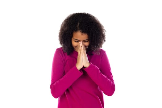 Teenager girl with afro hair wearing pink sweater isolated on a white background