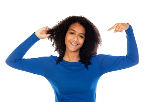 Teenager girl with afro hair wearing blue sweater isolated on a white background