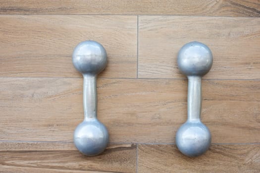 dumbbells   gym wooden floor  background