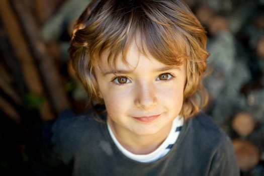 Adorable small child in the field looking at camera