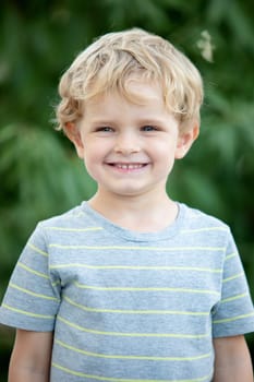 Happy child with blue t-shirt playing in the garden