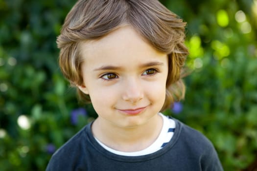 Adorable small child in the field looking at camera