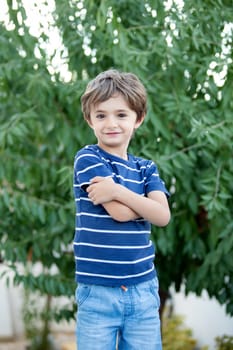 Adorable small child in the field looking at camera