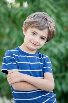 Adorable small child in the field looking at camera