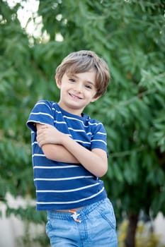 Adorable small child in the field looking at camera