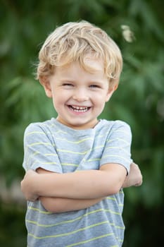 Happy child with blue t-shirt playing in the garden