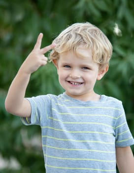 Happy child with blue t-shirt playing in the garden