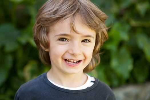 Adorable small child in the field looking at camera