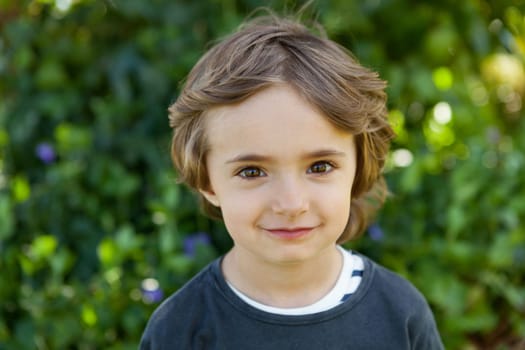 Adorable small child in the field looking at camera