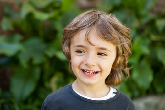 Adorable small child in the field looking at camera