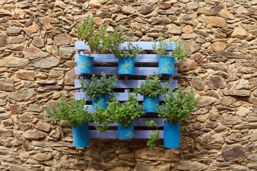 Beautifuful flowerpot recycling on a stone wall