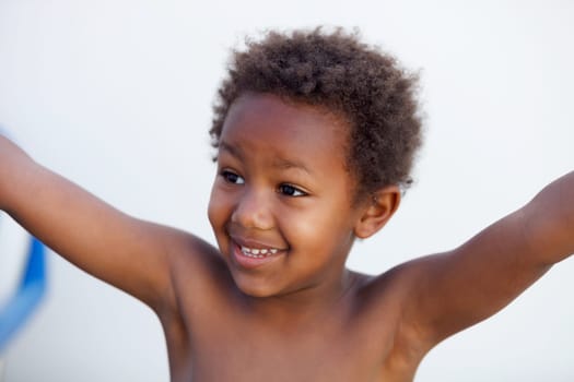 African little kid four years without a shirt on a summer day