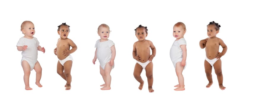 Beautiful babies in diaper standing up isolated on a white background