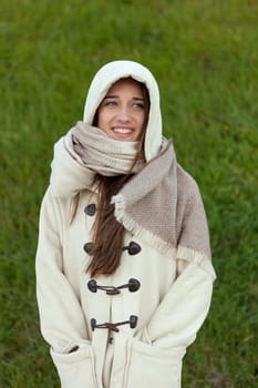 Sheltered girl with hood and scarf in the park