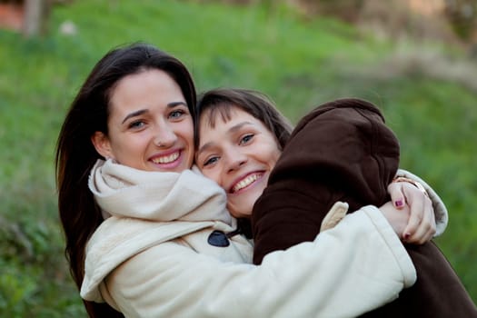 Nice sisters with blue eyes in a park