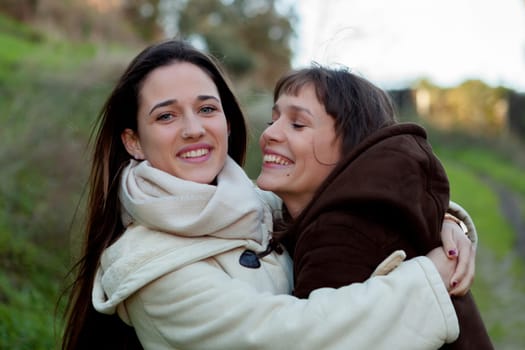 Nice sisters with blue eyes in a park