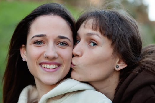 Nice sisters with blue eyes in a park