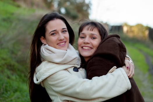 Nice sisters with blue eyes in a park