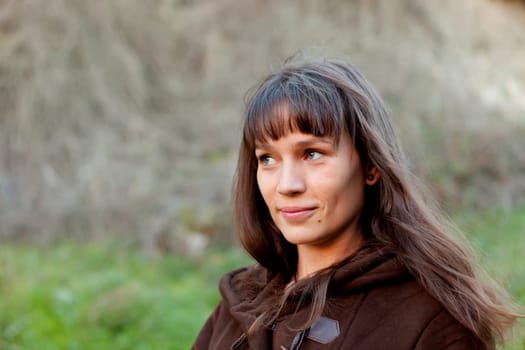 Beautiful brunette woman with blue eyes in the park