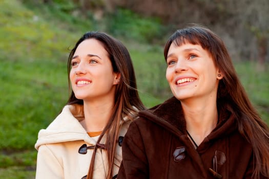 Nice sisters with blue eyes in a park