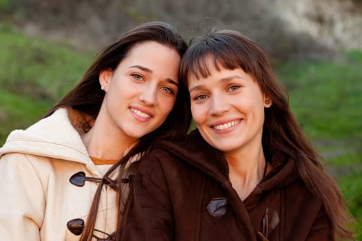 Nice sisters looking at camera with a beautiful smile