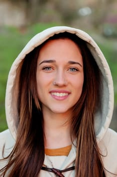 Smiling teen girl outside with a natural green of background