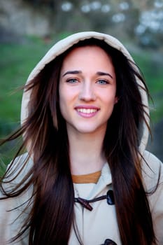 Smiling teen girl outside with a natural green of background