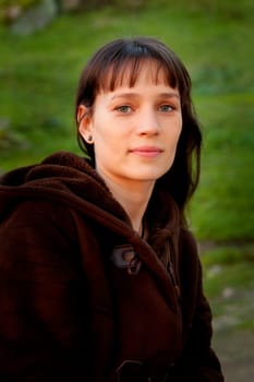 Beautiful brunette woman with blue eyes in the park