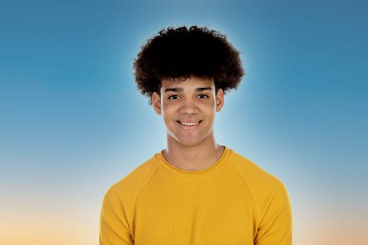 African guy with yellow T-shirt on a blue background