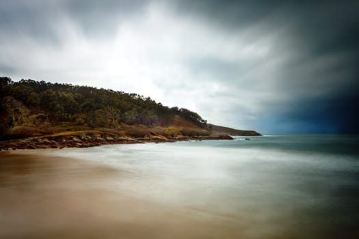 Beautiful seascape on a cloudy day with the sky and the water blurred