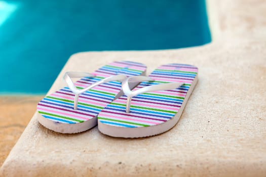 Color flip-flops near to the pool