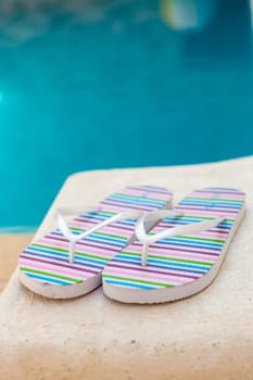Color flip-flops near to the pool