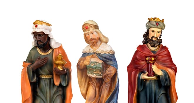 The three wise men. Ceramic figures isolated on white background