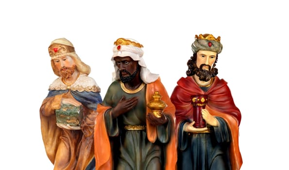 The three wise men. Ceramic figures isolated on white background