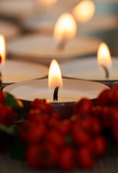 Christmas candles with berries. Decoration for holidays