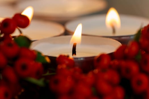Christmas candles with berries. Decoration for holidays