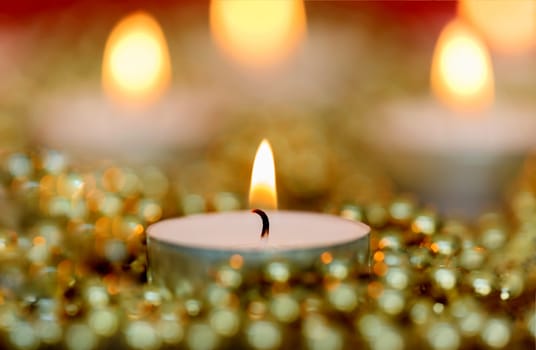 Christmas candles with golden decoration. Warm holidays