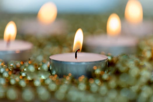 Christmas candles with golden decoration. Warm holidays