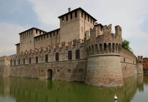view of historical fortification completely surrounded by a large moat in the middle of the village, the picture is shot from north east side..