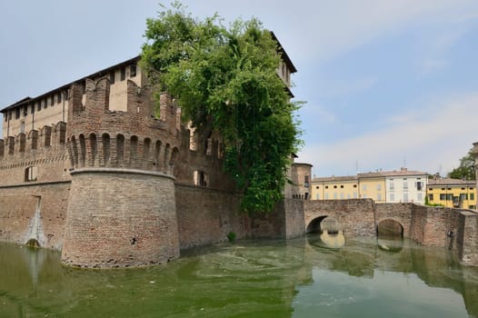 view of entrance bridge of historical fortification completely surrounded by a large moat in the middle of the village, the picture is shot from north east side..