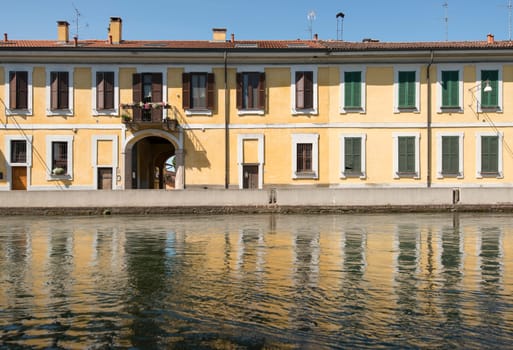 view of ancient traditional houses on embankment of artificial historic canal, shot in summer bright light.