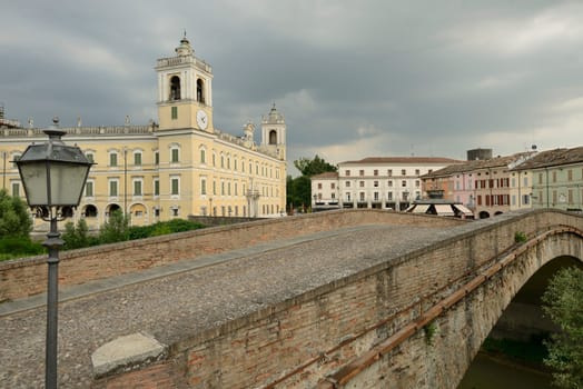 foreshortening of lamppost old bridge and west facade of historical royal palace built in eighteenth century, shot under bright stormy summer sky..