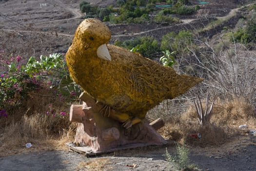 Giant bird in the garden of Villa Mogan, the historic windmill Molino de Viento, Mogan, Gran Canaria, Spain