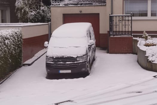 The car in the snow, covered with a white drift of snow.