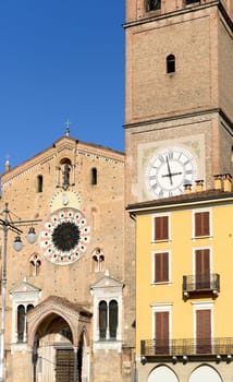 foreshortening  of the Romanesque Cathedral of the small town on the square and of old building near it   shot in bright winter light .