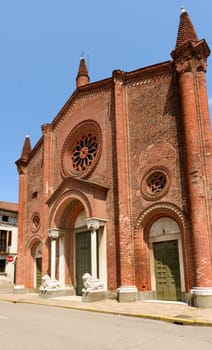 exterior view of main prospect of ancient Romanesque church in Soncino historical center, shot in bright summer light.