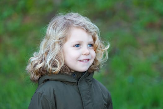 Small child with long blond hair enjoying of a sunny day